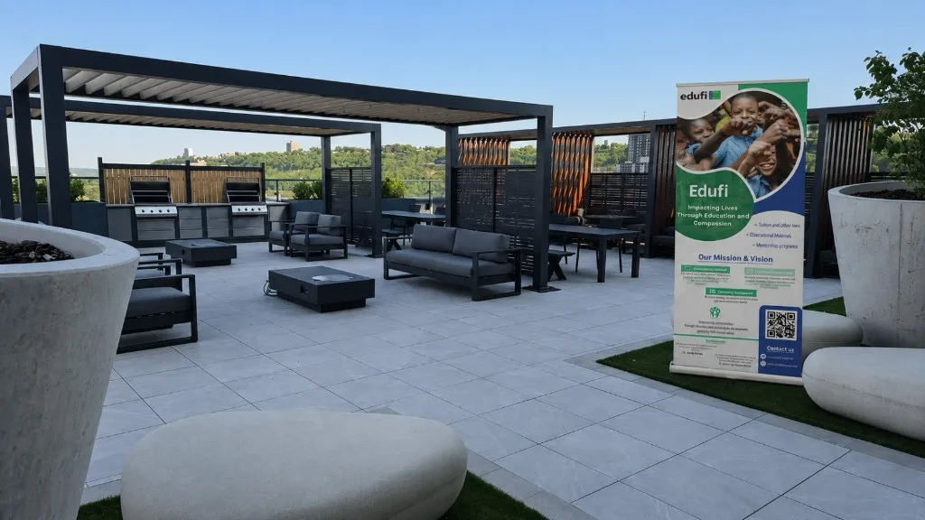 Rooftop terrace with an Edufi banner overlooking the city and green hills