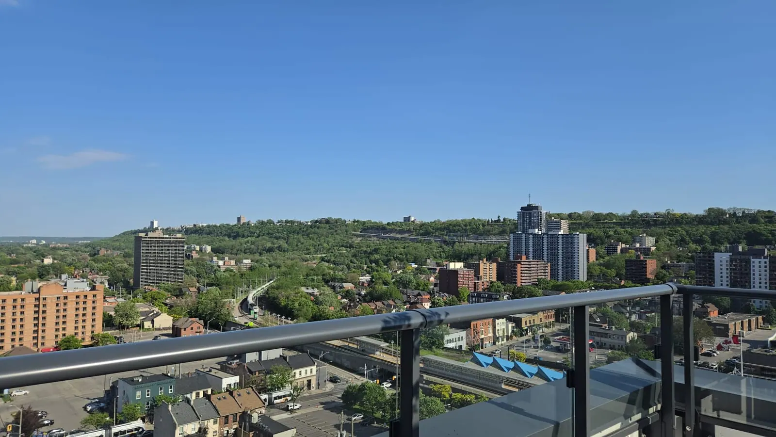 Open sky and skyline stretching to the escarpment over the rooftop railing