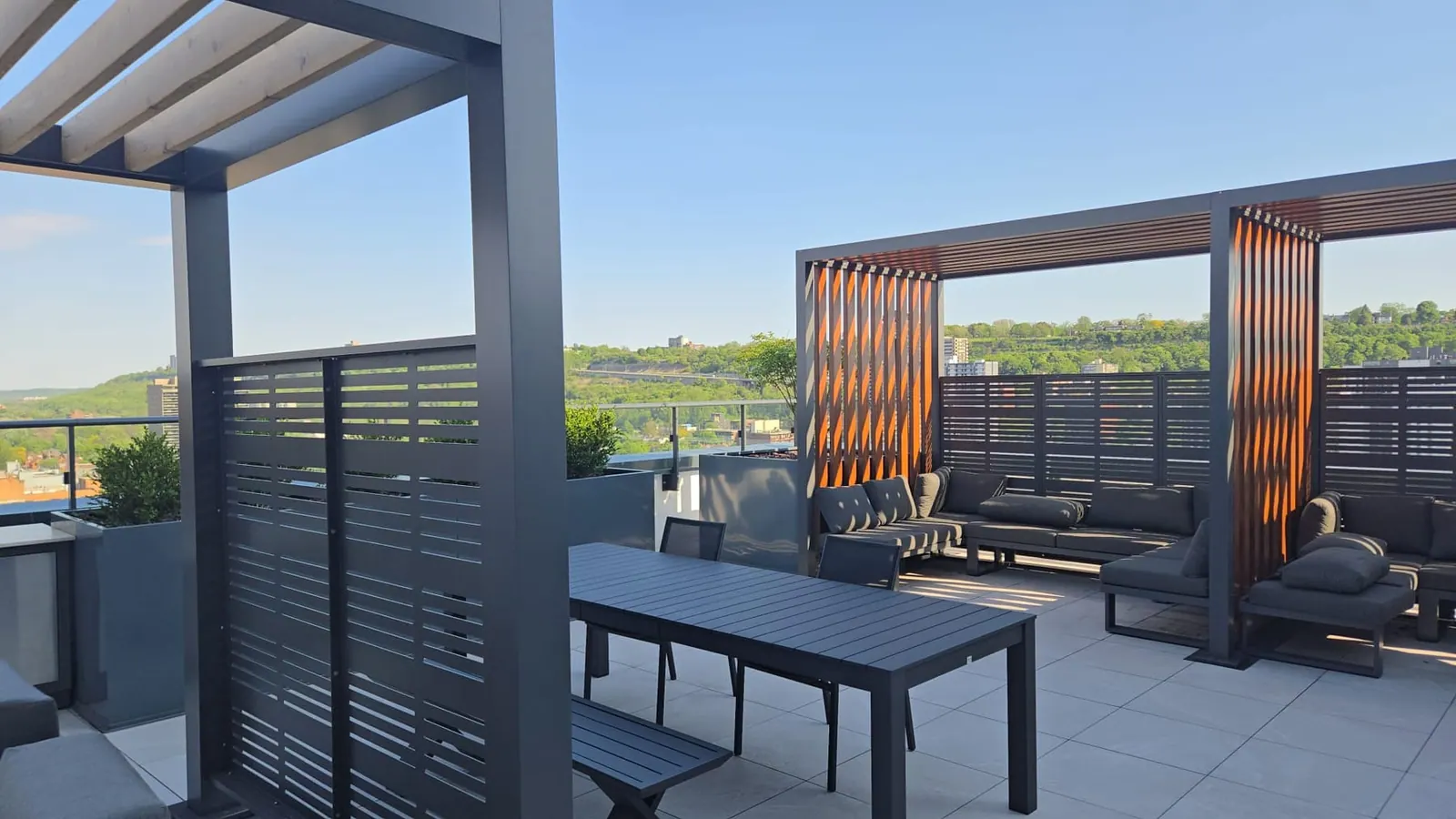 Warm cedar pergola and lounge seating on the rooftop terrace