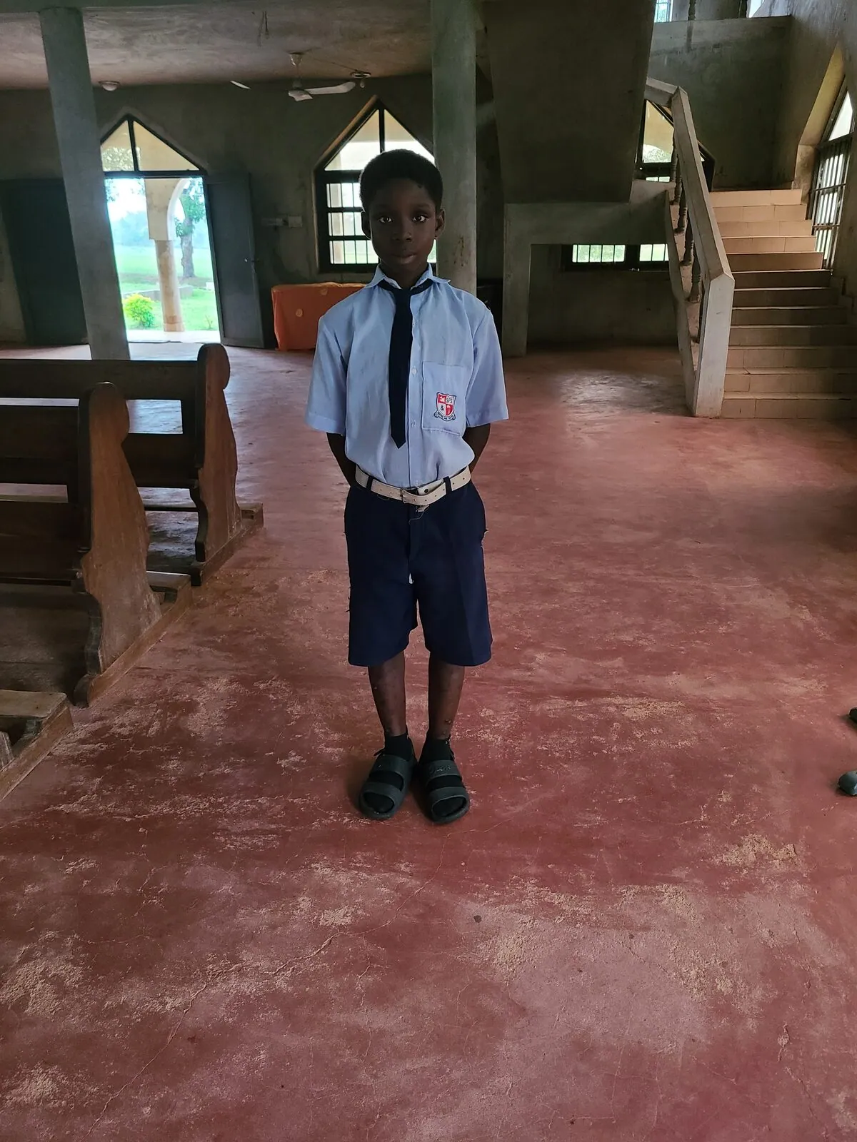 A sponsored student in uniform at school